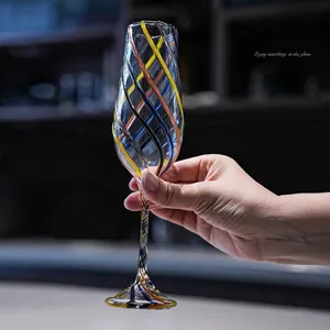 Handmade champagne glass featuring colorful spiral patterns and an elegant stem design