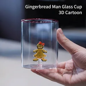 Creative transparent glass cup with a 3D gingerbread man figurine inside for drinks