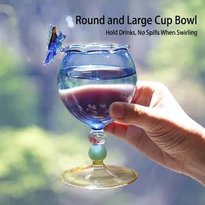 Elegant creative blue glass wine goblet with a butterfly ornament and rounded bowl