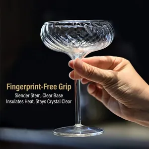 Vintage ribbed glass cocktail coupe with a long slender stem for elegant home barware.