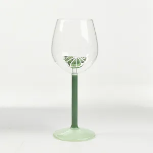 Creative lemon-themed wine glass with green stem and decorative fruit center