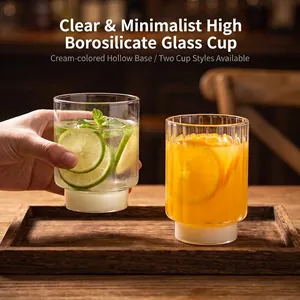 Two minimalist ribbed heat-resistant glass cups with milky white bases for coffee and juice