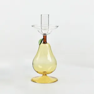 Creative yellow pear-shaped glass candle holder for romantic home decor and weddings.