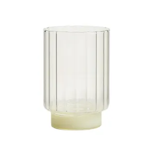 Modern elegant ribbed glass coffee cup with off-white base perfect for breakfast beverages