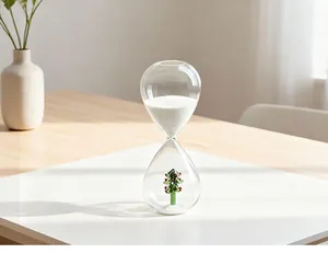 Detailed macro view of a clear glass hourglass featuring a festive miniature Christmas tree.
