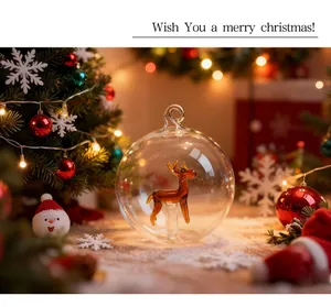 Close-up of a transparent glass Christmas ball with an amber glass reindeer inside