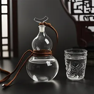 Elegant gourd-shaped glass liquor bottle with decorative cord and traditional cup