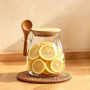 Clear Japanese glass storage jar with bamboo lid and wooden spoon for coffee beans