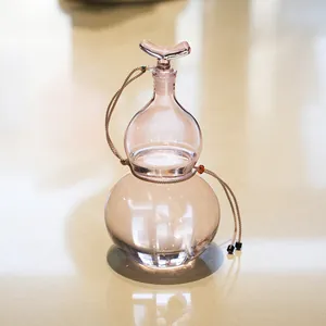 Elegant pink gourd-shaped glass wine bottle with decorative cord for liquor or cold brew