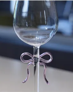 Macro detail of a purple glass bow on the stem of a crystal wine glass