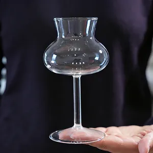 Unique willow waist clear glass goblet for cocktails and sweet wine held by hand