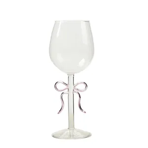 Elegant clear wine glass with a delicate pink glass bow accent on the slender stem