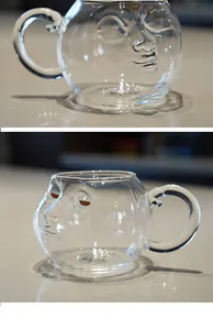 Detail view of creative glass mugs featuring a unique 3D human face design.