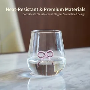 Heat-resistant borosilicate glass cup with an elegant pink bow decoration for juice