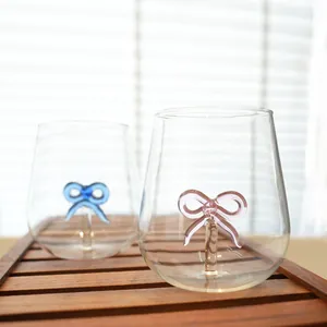 Creative pair of clear glass cups featuring pink and blue 3D glass bow-knot accents.