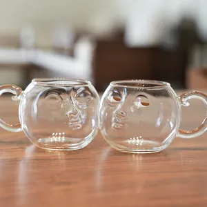 Set of two creative glass mugs with funny 3D human face design for couples and office use