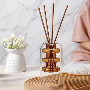 Elegant double-layered amber glass reed diffuser bottle with sticks for home fragrance