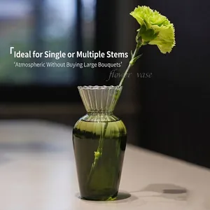 Elegant vintage green ribbed glass flower vase with a single carnation for home decor