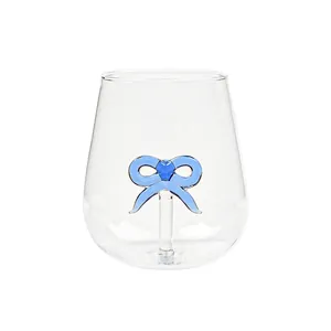 Creative clear glass drinking cup featuring an internal blue glass bow decoration for home