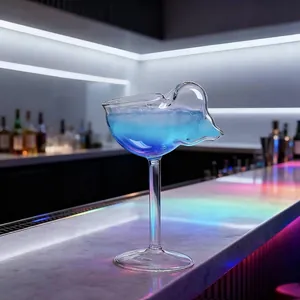 Elegant creative conch shell shaped cocktail glass on a modern illuminated bar counter