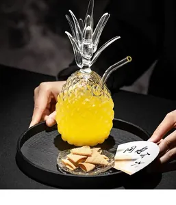 Close-up of a creative pineapple-shaped glass with relief texture and a glass straw