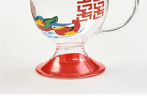 Detail of glass cup with traditional red Double Happiness and mandarin duck prints.