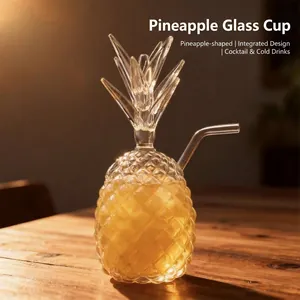Pineapple shaped glass cocktail cup with straw and embossed texture on wooden table