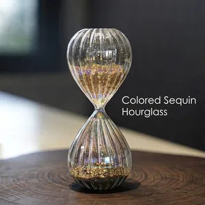 Iridescent glass hourglass timer with gold sequins for modern home office decor