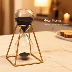 Elegant gold metal frame hourglass timer with black sand for modern home office decor