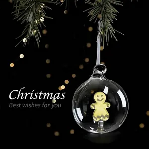 Festive Christmas transparent glass ball ornament with a cute gingerbread man inside