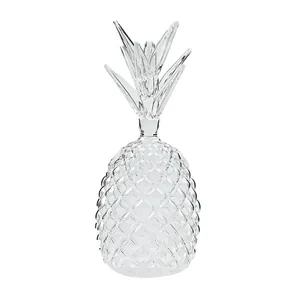 Clear pineapple-shaped glass cocktail cup with embossed texture on white background