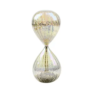 Decorative iridescent glass hourglass timer with sparkling gold and black glitter filler.