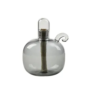 Elegant spherical grey glass oil lamp with a curved handle and clear windproof cover