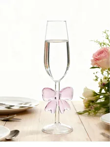 Elegant champagne flute featuring a romantic pink glass bow ornament on the stem