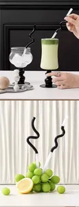 Set of two creative wave shaped black and white glass straws for drinks and juices