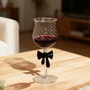 Elegant high-quality crystal red wine glass with a decorative black bowknot on the stem
