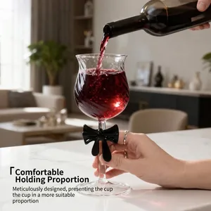 Elegant high borosilicate wine glass with black bow design pouring red wine in home setting