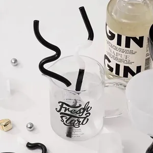 Artistic black and white bent glass straws for cocktails and juices