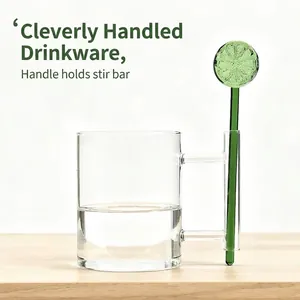 Creative transparent glass mug featuring a unique hollow handle with a green lime stirring rod