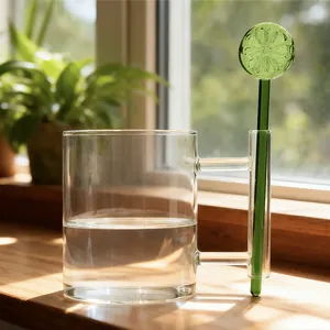 Creative glass mug with lime slice stirrer on a natural wooden windowsill