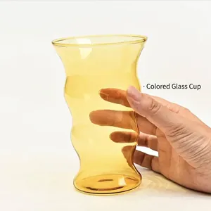 Modern wavy amber borosilicate glass cup for hot and cold beverages like coffee and tea