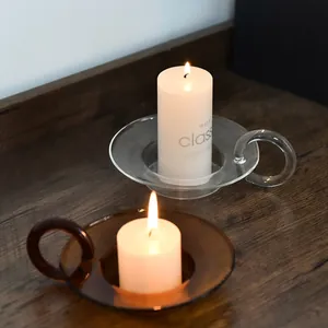 Vintage European style colored glass candle holder with handle, featuring white pillar candle