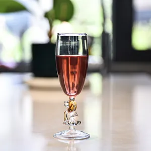 Elegant hand-blown champagne flute with a cute dog shaped stem for cocktails and vintage wine