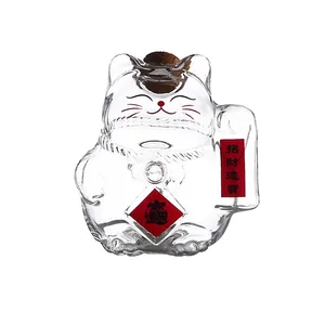 Maneki-neko shaped transparent glass storage jar with a cork lid for coins or wishes.