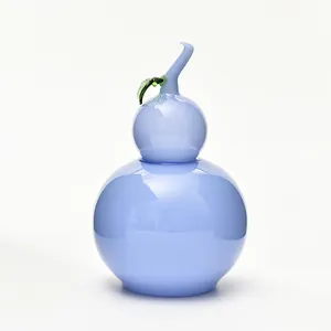 Tarro decorativo de cristal azul claro en forma de calabaza con tapa de hoja verde