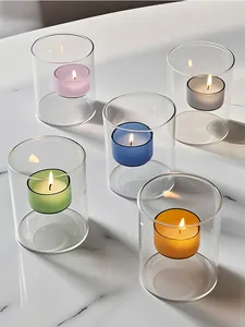 Detalle de portavelas de vidrio de colores suspendidos sobre superficie de mármol