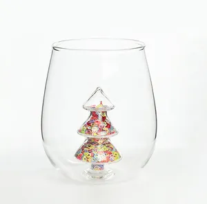 Detail shot of a clear glass cup featuring an internal sequin-filled Christmas tree.