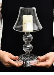 Macro detail view of elegant lamp-shaped glass candle holder with ribbed pedestal base