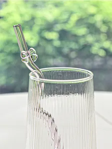 Detailed close-up view of a clear glass straw featuring a cute bow-knot decoration.