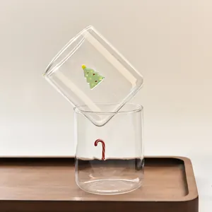 Set of two heat-resistant Christmas glass cups with tree and candy cane patterns
